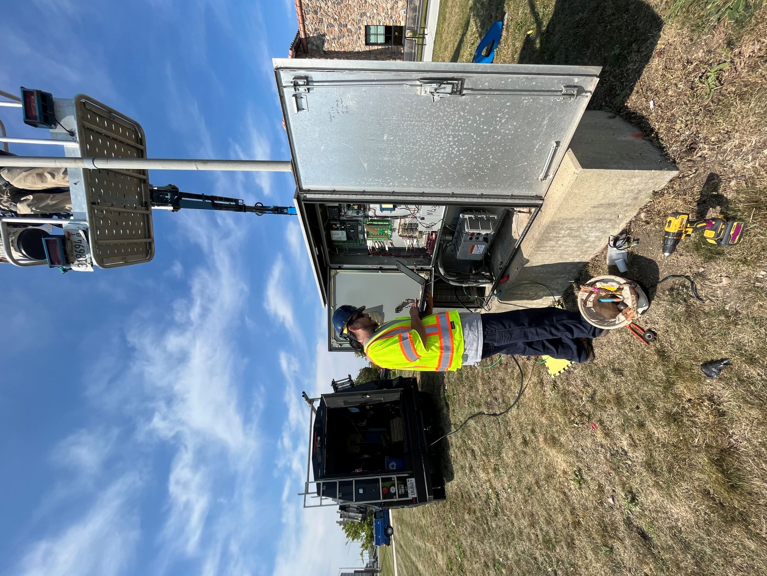 person working outside on an open electrical cabinet